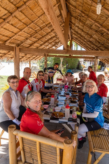 A Group Of People Sitting At A Table Description 