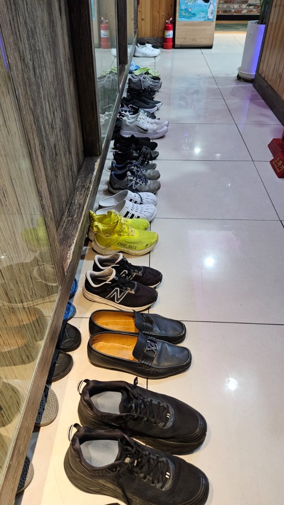 A row of shoes on the floor

Description automatically generated