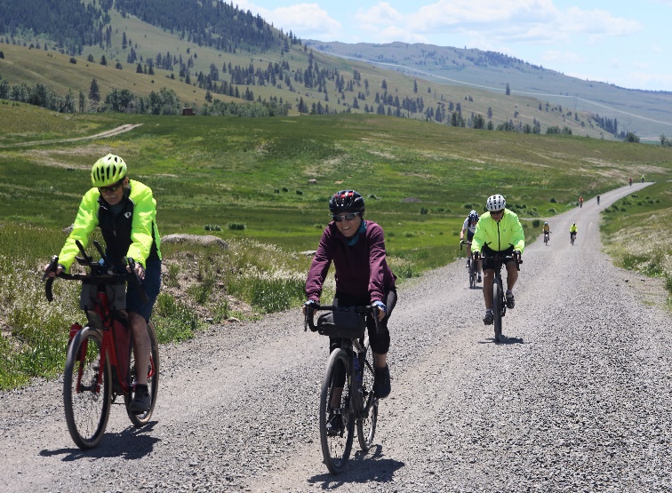 A group of people riding bicycles on a gravel road

Description automatically generated