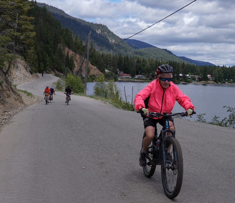 A group of people riding bikes on a road

Description automatically generated