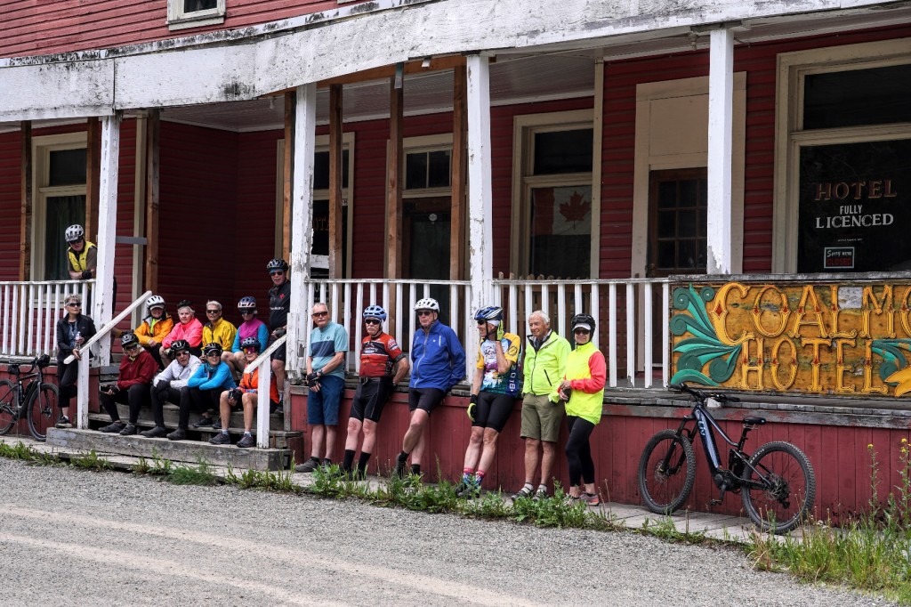 A group of people sitting on a porch

Description automatically generated