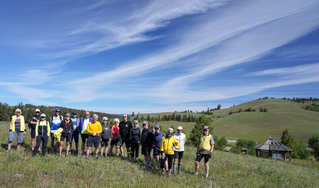 A group of people standing in a field

Description automatically generated