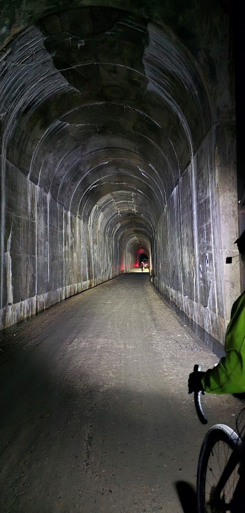 A person standing in a tunnel

Description automatically generated