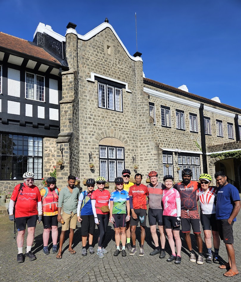 A group of people in front of a building

Description automatically generated