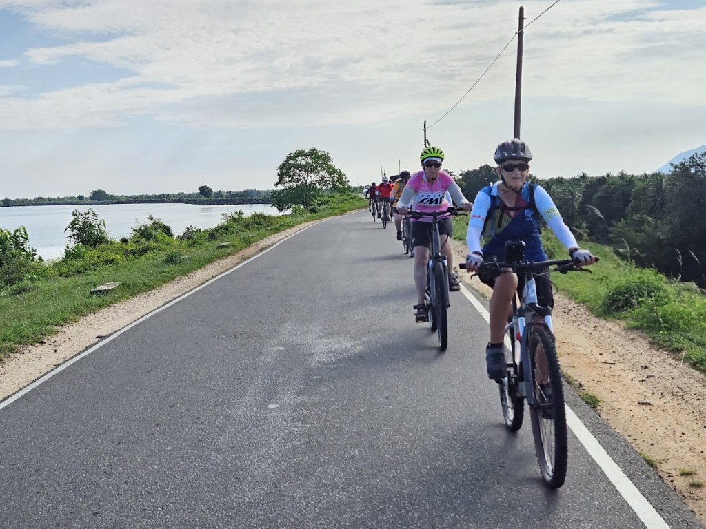 A group of people riding bicycles on a road

Description automatically generated