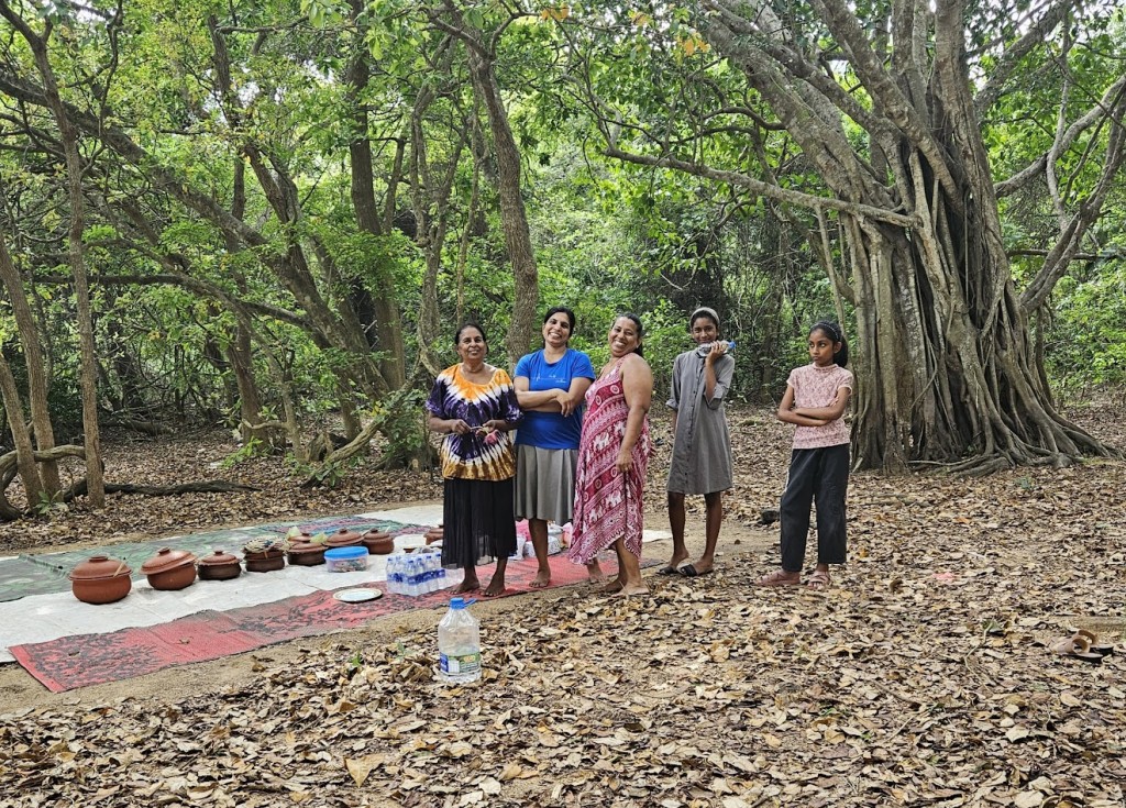 A group of women standing outside

Description automatically generated