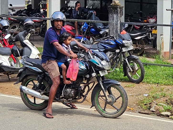 A person and child on a motorcycle

Description automatically generated