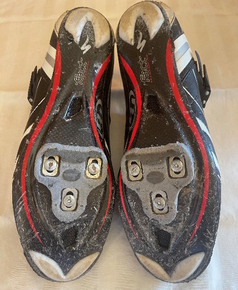 A pair of black shoes with white and red trim

AI-generated content may be incorrect.
