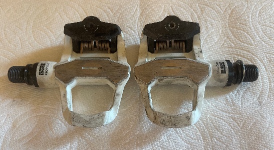 A pair of metal foot pedals

AI-generated content may be incorrect.