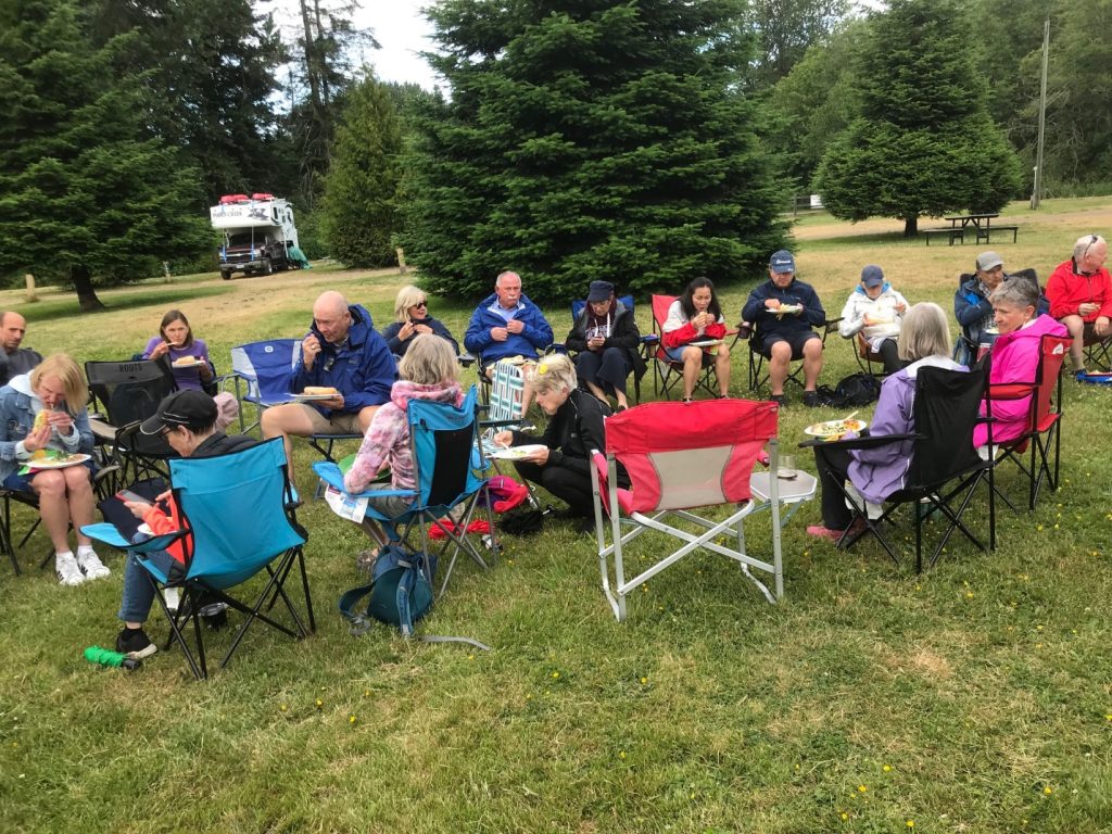 A group of people sitting in chairs outside

AI-generated content may be incorrect.