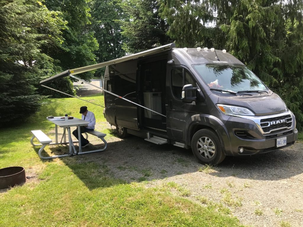A person sitting at a table in front of a black van

AI-generated content may be incorrect.